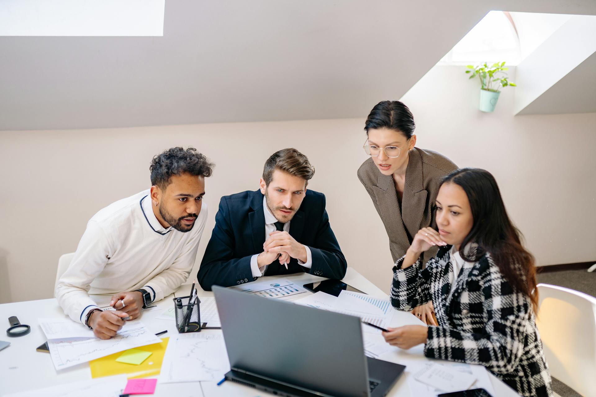 From Syllabus to Sales Page: Write Copy That Converts image Team reviews website layout and call-to-action placement on a laptop screen